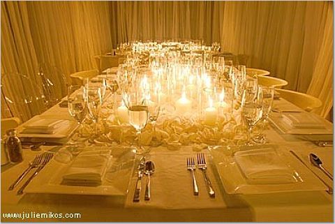  shaped and sized candles in groups down the centre of the table