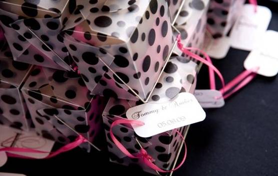 Guest tables were decorated with hot pink and black white polka dots