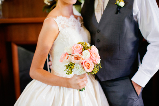  around a simple peach bouquet and the most beautiful lace wedding gown