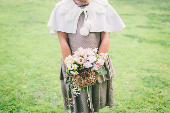 flower girl in grey dress with bouquet